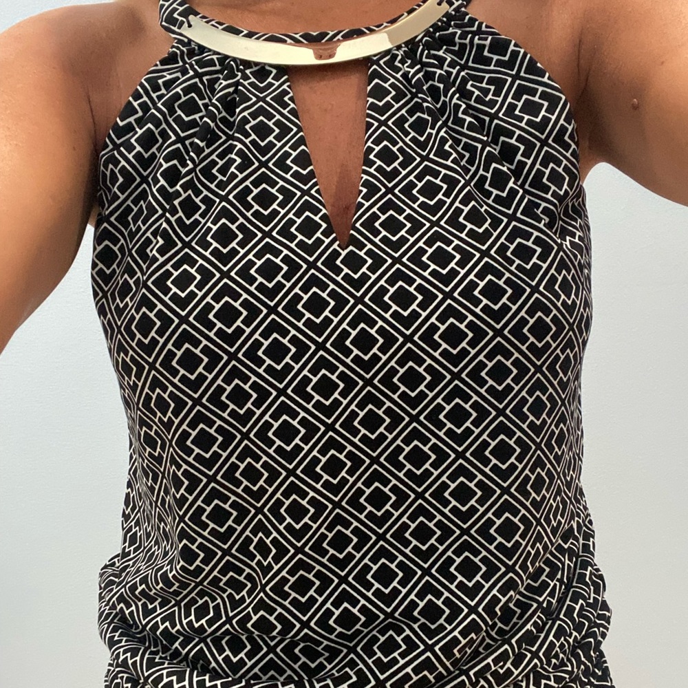 Super cute dressy tank with built in necklace like hardware.